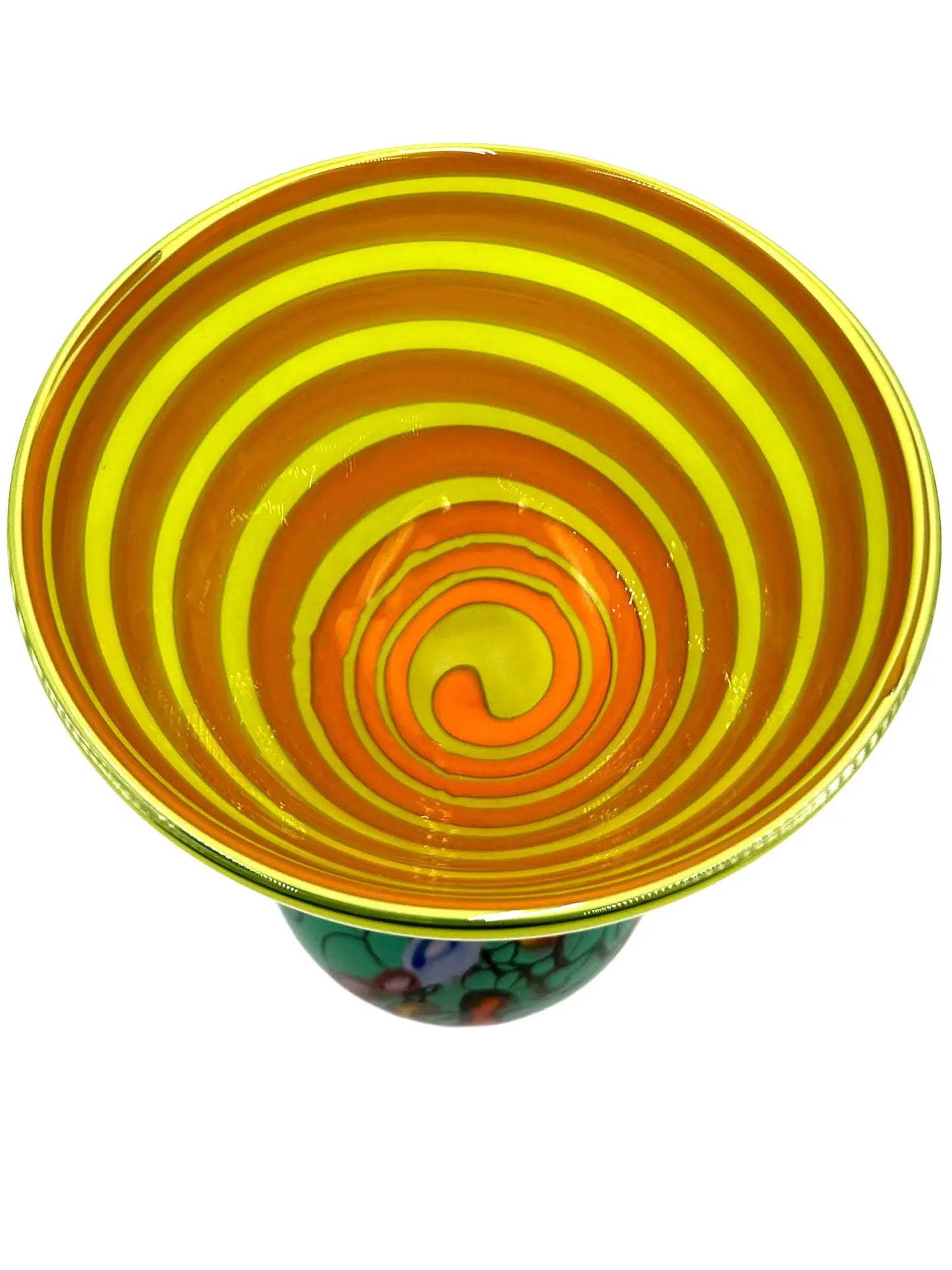This vibrant glass sculpture, 'Mini Me' by Steve Palmer, showcases a bold abstract design with colorful swirls and organic patterns on a rounded base, contrasted by a translucent lime green top with subtle horizontal stripes. Its playful colors and shapes make it a striking statement piece suitable for contemporary and artistic settings. Dimensions are approximately 7 inches wide, 9 inches high, and 4.5 inches deep, weighing 4.4 pounds, and it is crafted from handblown glass.