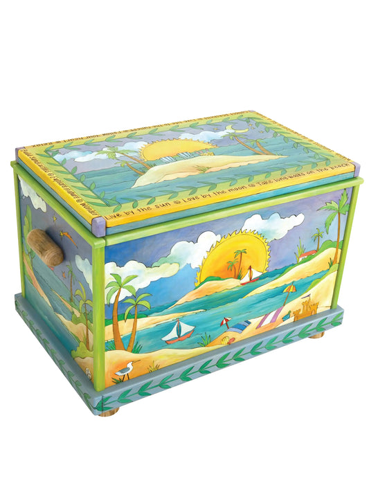 This handcrafted wooden chest features hand-painted seaside scenes, including sailboats, sandy shores, and a sunset framed by palm trees. Decorated with inspiring phrases like "Live by the sun" and "Explore Nature," it serves as a charming storage solution or cozy window bench for coastal homes. Measuring 35" wide, 24" high, and 22.5" deep, it’s crafted in the USA and ideal for enhancing coastal decor while providing functional storage.