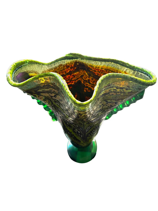 This large, fluted glass vessel, titled 'Hope Springs Eternal,' is a stunning display of color and craftsmanship. It features vivid lime green and deep purple hues, complemented by winter-like tones. The textured surface, ridged sides, and flared silhouette create an elegant flow of color and movement, making it a striking statement piece. Dimensions are approximately 13.75 inches in width and 11.25 inches in height, weighing 4.56 pounds, crafted from glass. Perfect for decorative use.