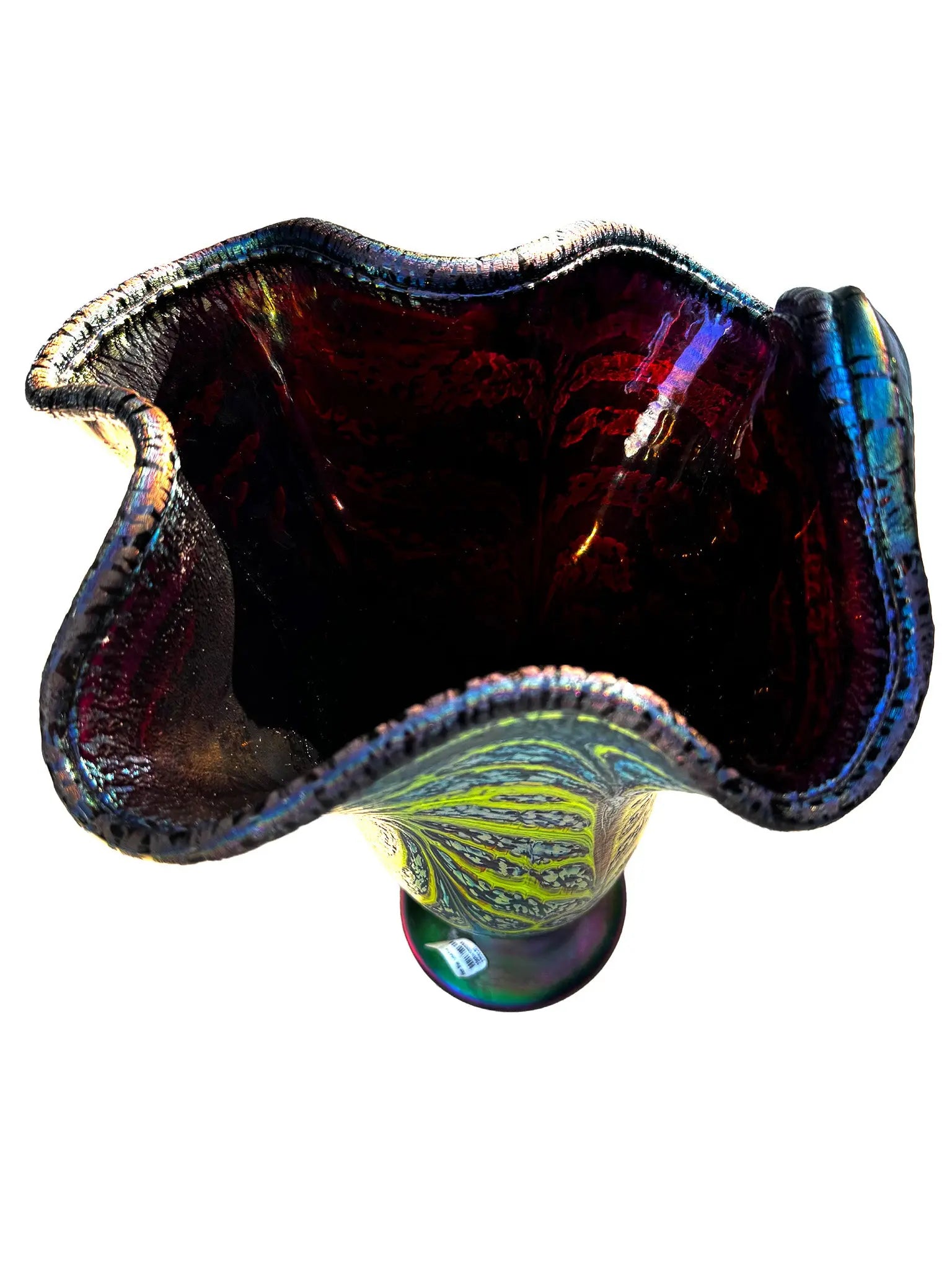 This large, fluted glass vessel, Rachel I, showcases modern craftsmanship with its opaque blue base and vivid lime green veining that meanders organically across the surface, creating a dynamic pattern reminiscent of flowing water. The fluted rim is accented by a dark, iridescent edge that shifts colors as it catches the light, reflecting hues that evoke minerals and natural elements. Its elegant design and craftsmanship make it a striking decorative piece suitable for contemporary interiors.