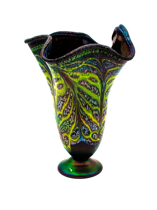 This large Rachel I glass vessel features a calming blue base with organic lime green veining and an iridescent fluted rim that shifts colors in light, reflecting mineral-like imagery. It measures approximately 10" wide by 13.5" high and weighs 3.9 lbs, showcasing modern glass artistry.