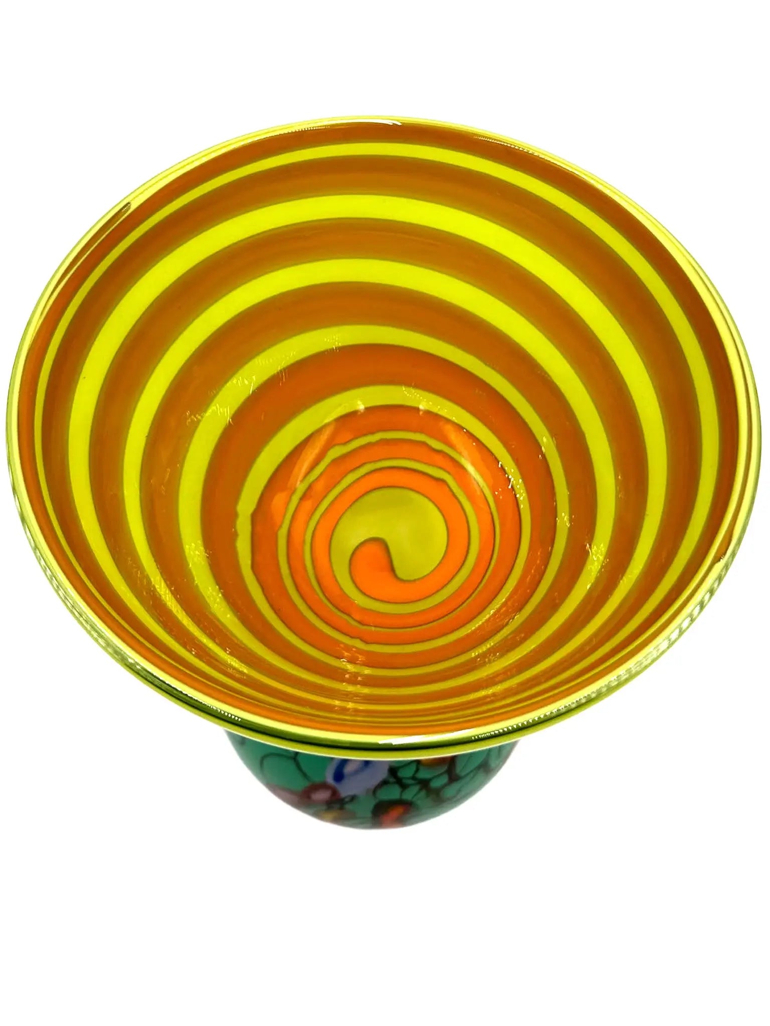 This vibrant glass sculpture, 'Mini Me' by Steve Palmer, showcases a bold abstract design with colorful swirls and organic patterns on a rounded base, contrasted by a translucent lime green top with subtle horizontal stripes. Its playful colors and shapes make it a striking statement piece suitable for contemporary and artistic settings. Dimensions are approximately 7 inches wide, 9 inches high, and 4.5 inches deep, weighing 4.4 pounds, and it is crafted from handblown glass.