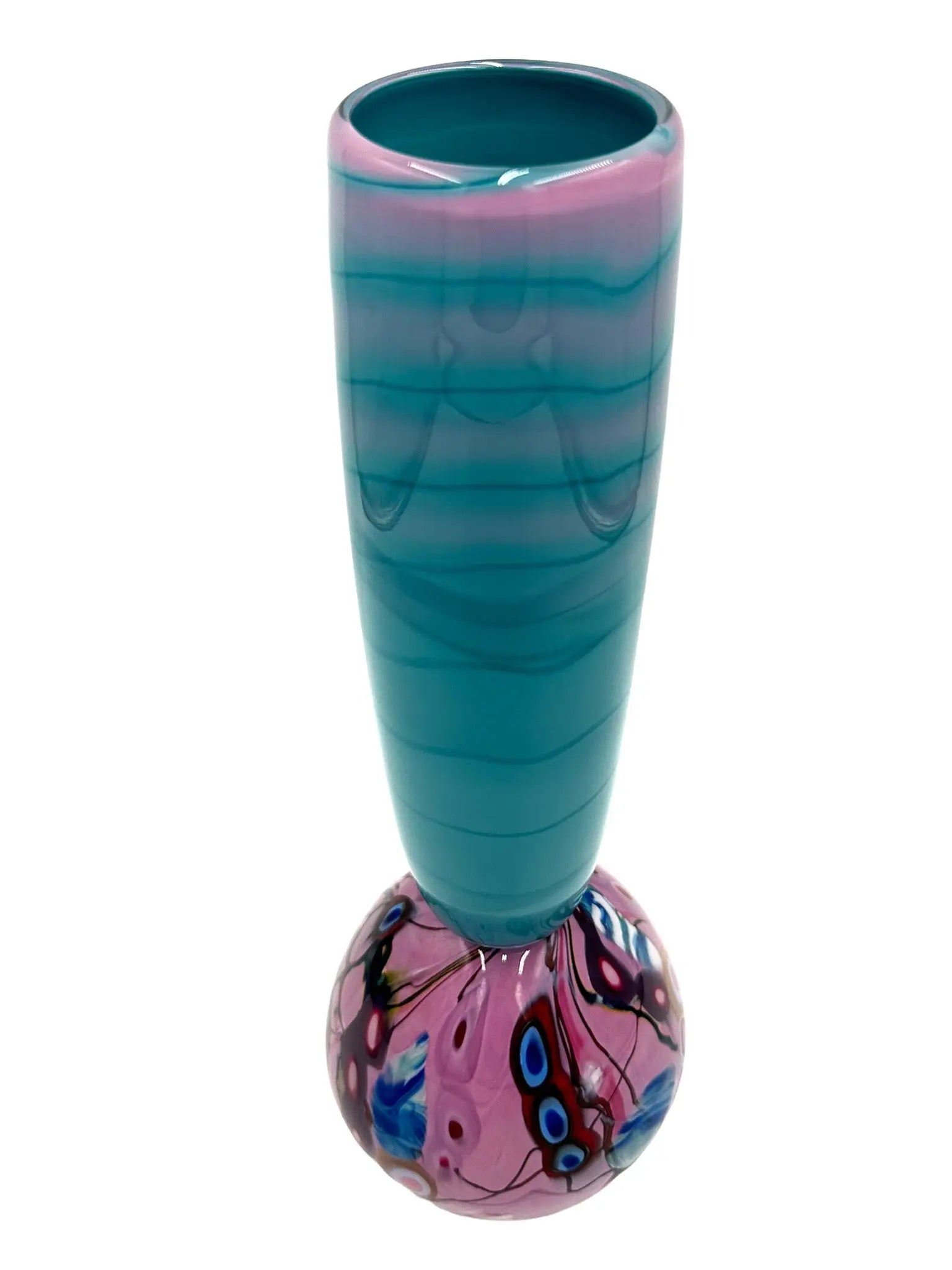 This glass art piece titled 'Cotton Candy' by Steve Palmer features a sleek turquoise body with a vibrant swirl of purple, pink, and blue at the base, blending contemporary design with craftsmanship. It can serve as a sculpture or functional vase, measuring 3" wide, 15" high, and weighing 3.7 lbs.