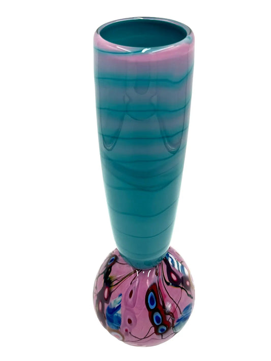 This glass art piece titled 'Cotton Candy' by Steve Palmer features a sleek turquoise body with a vibrant swirl of purple, pink, and blue at the base, blending contemporary design with craftsmanship. It can serve as a sculpture or functional vase, measuring 3" wide, 15" high, and weighing 3.7 lbs.
