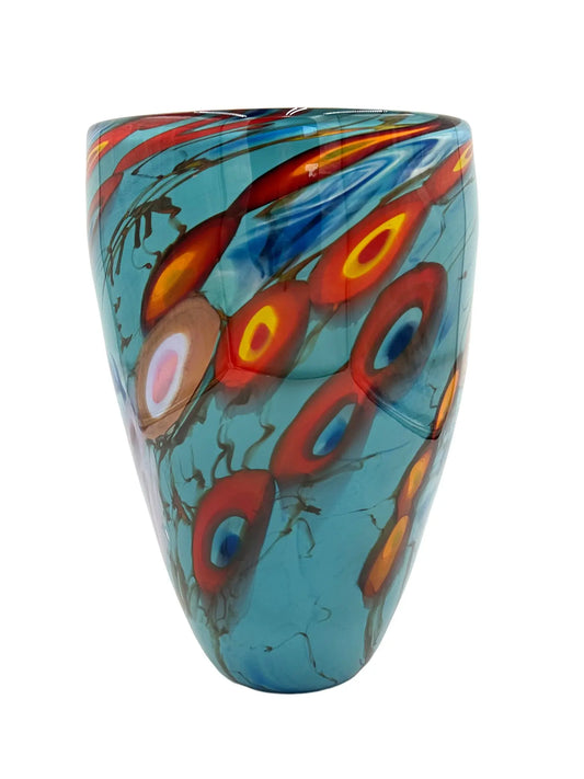 A vibrant glass vessel named Oceanic by Steve Palmer, featuring a turquoise base with abstract swirling patterns in red, orange, and yellow, inspired by flowing tides and coral reefs. The vessel measures approximately 7.75 inches wide, 12 inches tall, and 7.75 inches deep, weighing 5.95 pounds. Suitable as a sculpture or floral display.