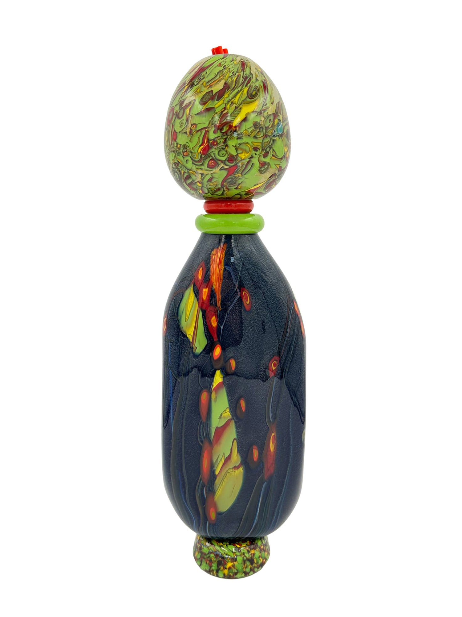 Benjamin Blue is a unique modern sculpture featuring a deep, dark base with vibrant abstract patterns in yellow, orange, and red, creating striking visual contrast. The top is adorned with a green and red speckled design, adding a playful artistic touch. Handcrafted with care, this piece measures approximately 5 inches wide, 17 inches tall, and 2.5 inches deep, weighing 4.8 pounds. Made from handblown glass, it suits eclectic or artistic interiors as a distinctive collector's item.