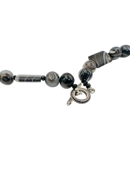 Amy Kahn Russell sterling silver statement necklace featuring a white tiger face pendant, black onyx, rutilated quartz, and pearls.