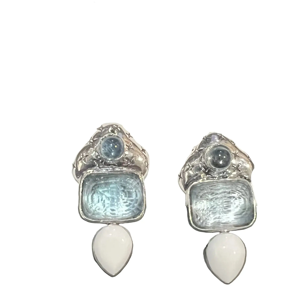 A pair of silver drop earrings with light blue textured square stones, small round blue and gray stones, and white teardrop pendants.
