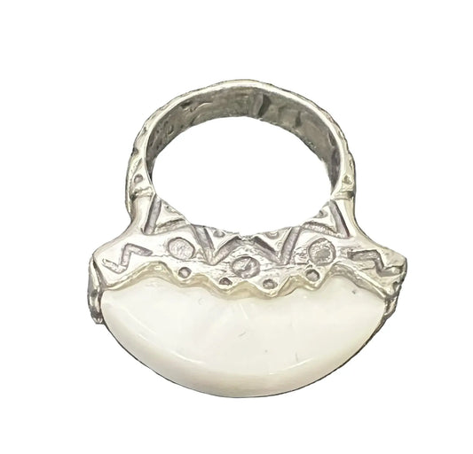 A sterling silver ring featuring a large, smooth white crescent-shaped stone or shell inlay. Wear it alone or stack it with other rings for a layered look.
