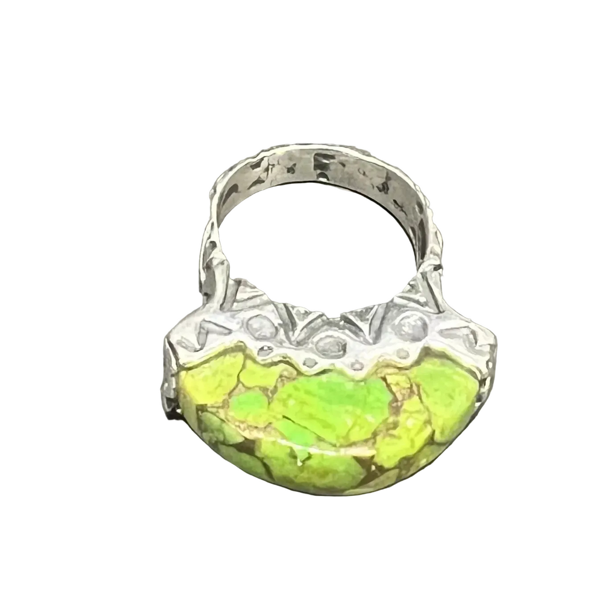 A sterling silver ring featuring a large, organic-shaped green stone with brown matrix veining worn on its own, it can also be stacked with other rings for a layered, collected look.